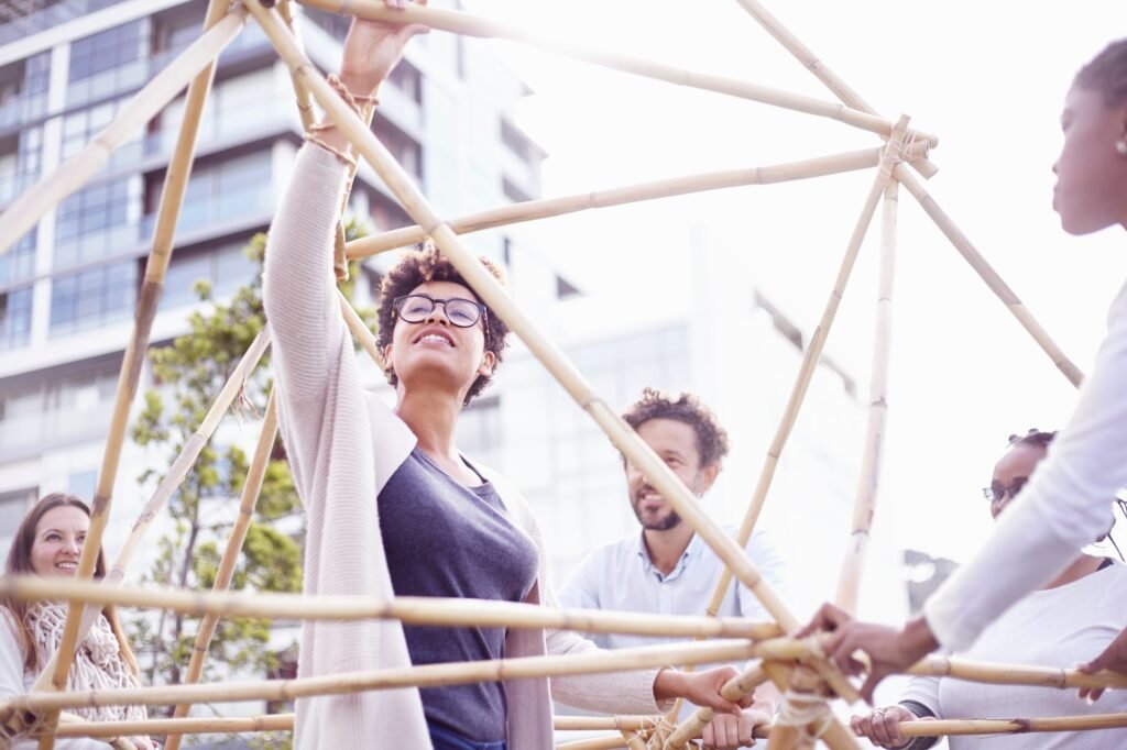Low angle view of colleagues in team building task building wooden structure